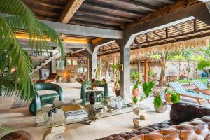 a living room with a table and chairs at The Corduroy Hotel in Canggu