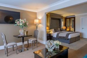 A bed or beds in a room at Killarney Oaks Hotel