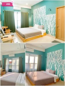 a bedroom with two beds and blue walls at Joy Hotel Phú Yên in Tuy Hoa
