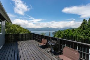 a balcony of a house with a view of the water at Villa Noël HAKONE FUJI Sauna&Open Air Bath in Hakone