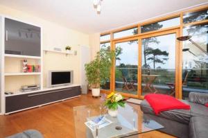 a living room with a couch and a table at Haus in der Duene _ Objekt 25954 in Warnemünde