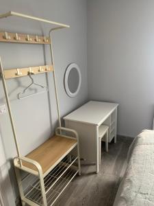 a small bedroom with a desk and a bed at Farsnagh Cottage in Newport Trench