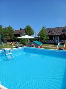 a large blue swimming pool with a slide at Ostrivky in Svityazʼ