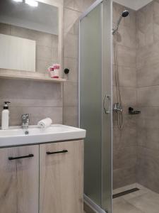 a bathroom with a sink and a shower at Iris Studios Chios in Karfas