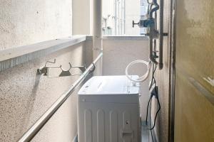 a washing machine in a room with a window at Raffine Nihonbashi in Osaka