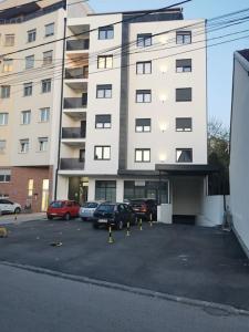 a parking lot with cars parked in front of a building at Amar 3 in Zemun