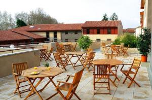 a group of tables and chairs on a patio at Studio Cité médiévale 250 m in Carcassonne