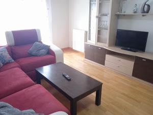 a living room with a couch and a coffee table at Al lado de la feria en dos habitaciones Compartir con los propietarios in Albacete