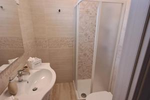 a bathroom with a shower and a sink and a toilet at Punta Grossa - Porto Cesareo in Punta Prosciutto