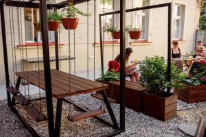 a porch with a bench and potted plants on it at Prague Dream Hostel in Prague