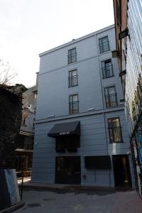 a tall white building with an awning on it at Persona Hotel Galata in Istanbul