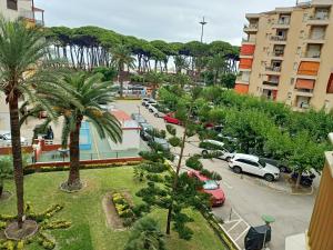 an aerial view of a parking lot with palm trees at SEAFRONT APARTMENT PINEDA BEACH in La Pineda