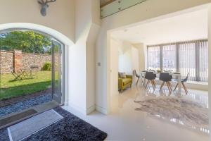 an open living room with a table and chairs at Tun House in Letheringsett