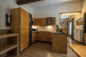 a kitchen with wooden cabinets and a refrigerator at Ferienwohnung Kobler in Landeck