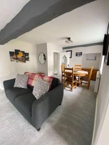 a living room with a couch and a table at Stunning Two bed cottage in Rhuddlan
