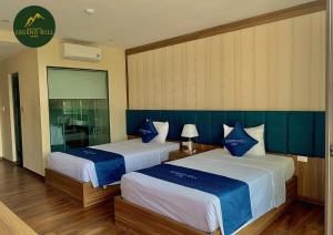 a hotel room with two beds with blue and white sheets at Thái Nguyên Legend Hill in Thái Nguyên