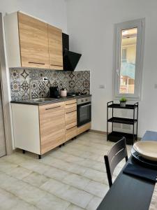 a kitchen with a stove and a counter top at Casa Lina in Punta Secca