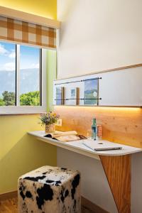 a bathroom with a desk with a cow print stool at Hey Lou Hotel Piding in Piding