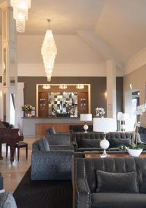 a hotel lobby with couches and a bar at Killarney Oaks Hotel in Killarney