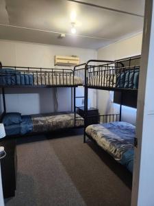 a room with two bunk beds in a room at House on Ryan in Broken Hill
