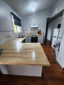a kitchen with a wooden counter top in a room at House on Ryan in Broken Hill