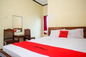 スラカルタにあるRedDoorz near Candi Sukuh Karanganyarのベッドルーム1室(赤い毛布付きのベッド1台付)