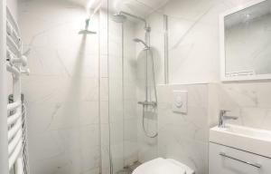 a white bathroom with a shower and a toilet at Ciseaux 4F - Saint Germain des Prés in Paris