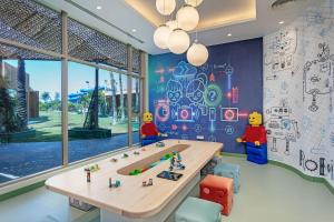a room with a table and four lego figures on the wall at Titanic Deluxe Lara in Lara
