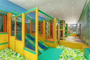 a play room with a bunch of apples at Titanic Deluxe Lara in Lara