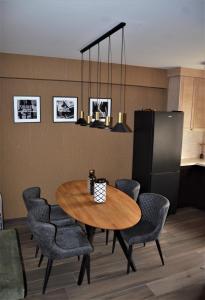 Casa Nuova في كوتور: غرفة طعام مع طاولة وكراسي خشبية