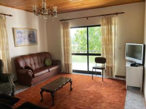 a living room with a couch and a tv at Casa Morais in Vinhais