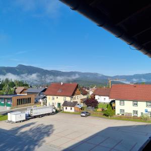 a view of a town with houses and a truck at Mountain view apartments in Bad Mitterndorf