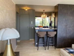 a kitchen with a counter and stools in a room at Appartement Le Lavandou, 3 pièces, 4 personnes - FR-1-308-179 in Le Lavandou