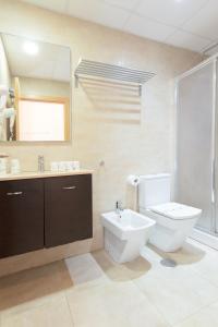 a bathroom with a toilet and a sink and a mirror at Apartamento El Carmen by Be Alicante in Alicante