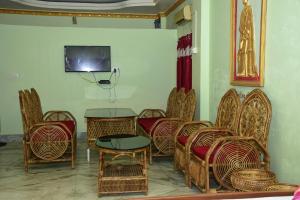 Habitación con sillas, mesa y TV. en Resort Everest, en Mādāri Hāt