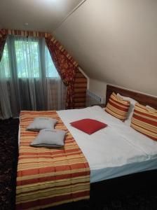 a bedroom with a large bed with pillows on it at Фортеця in Kyiv