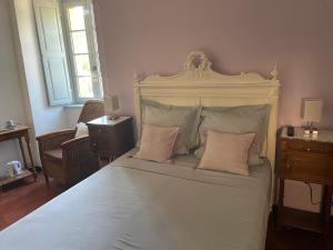 a bedroom with a large white bed with two pillows at Maison d'Hotes Le Val d'Aleth in Alet-les-Bains