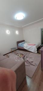 a room with two beds and a rug at Акварелі 2 in Vyshneve