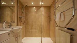 a bathroom with a shower and a sink at Glen Cottage in Comrie +34 photos