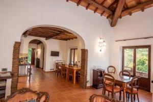 a kitchen and dining room with a table and chairs at Luxury Country Villa Daniele in Poggio Sommavilla