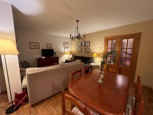 a living room with a table and a couch at Apartamento Posada de Llanes in Posada