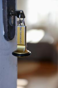 a gold tag hanging from a door knob at Gut Basthorst in Basthorst