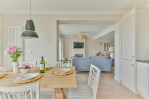 a dining room and living room with a table and chairs at Driftwood - New Listing in Brixham