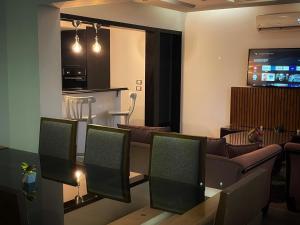 a living room with a couch and a tv at Cosy 2 bedrooms apartment with garden in Cairo