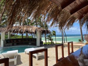 a resort with a swimming pool and the ocean at Gecko Resort in Watamu