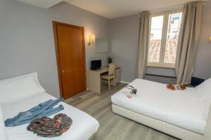 Postel nebo postele na pokoji v ubytování Hotel L'Aretino