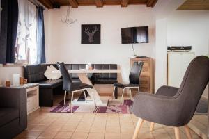 a living room with a couch and a table and chairs at Ferienhaus Blick Falkenstein in Lindberg