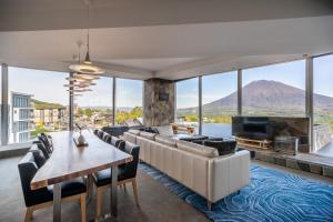 a living room with a couch and a table and a television at The Vale Niseko in Niseko