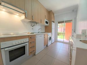 a kitchen with a sink and a dishwasher at Garden BEACH LUXURY APARTMENT Litoralmar in Portimão