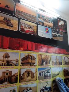 a wall of posters on the side of a bus at Jasmeet hotels in Jaisalmer